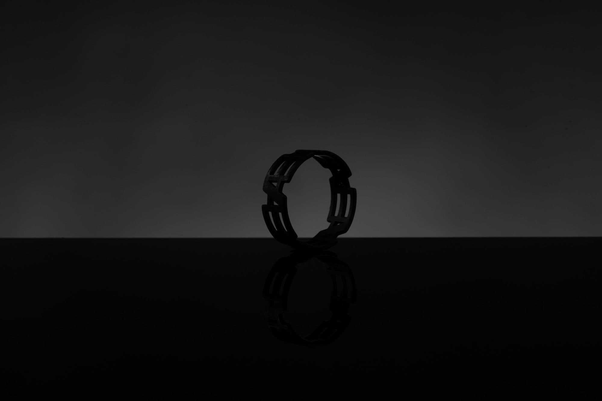 Silhouette of the Inverted Monogram ring against a soft grey backdrop